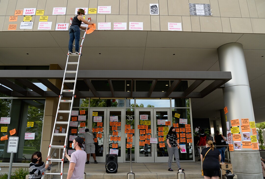 (Francisco Kjolseth  |  The Salt Lake Tribune) A group of about twenty people again showed up at the Salt Lake County District AttorneyÕs Office on Sunday, June 21, 2020, as part of their vow to come out every day until officials release the investigation into Bernardo Palacios-CarbajalÕs death by police. They hung protest signs on the building's windows.