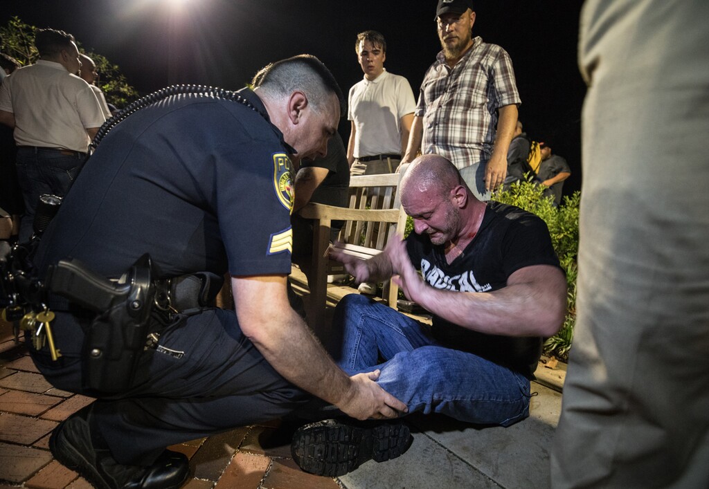 (Evelyn Hockstein  |  For The Washington Post)  Chris Cantwell, known as the "Crying Nazi," is helped by police after being overcome with tear gas during the white nationalist rally in Charlottesveille, Virginia, in August 2017.