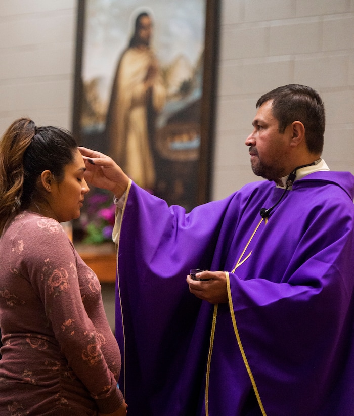 (Rick Egan  |  The Salt Lake Tribune)     Maria Camarena receives the ashes from the Rev. Jose Fidel Barrera-Cruz  during Ash Wednesday Mass at Our Lady of Guadalupe Church in Salt Lake City on Wednesday, March 6, 2019.