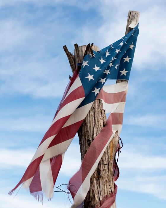 (Emil Lippe | The New York Times)
A tattered American flag on a fence post in Angus, Texas, Dec. 7, 2021. "I don't know why Senator Joe Manchin apparently decided to go back on an explicit promise he made to President Biden," writes The New York Times columnist Paul Krugman. "What I do know is that there will be huge human and, yes, economic costs if Biden's moderate but crucial spending plans fall by the wayside."