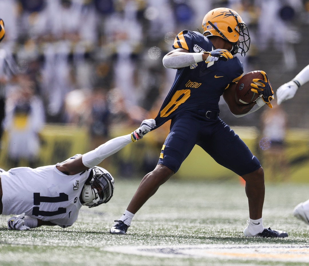 BYU defensive back Isaiah Herron (11) pulls at University of Toledo Devin Maddox (8) jersey during a college football game at the Glass Bowl in Toledo, Ohio on Saturday September 28, 2019. UT defeated BYU 28-21. (Rebecca Benson/The Blade via AP)