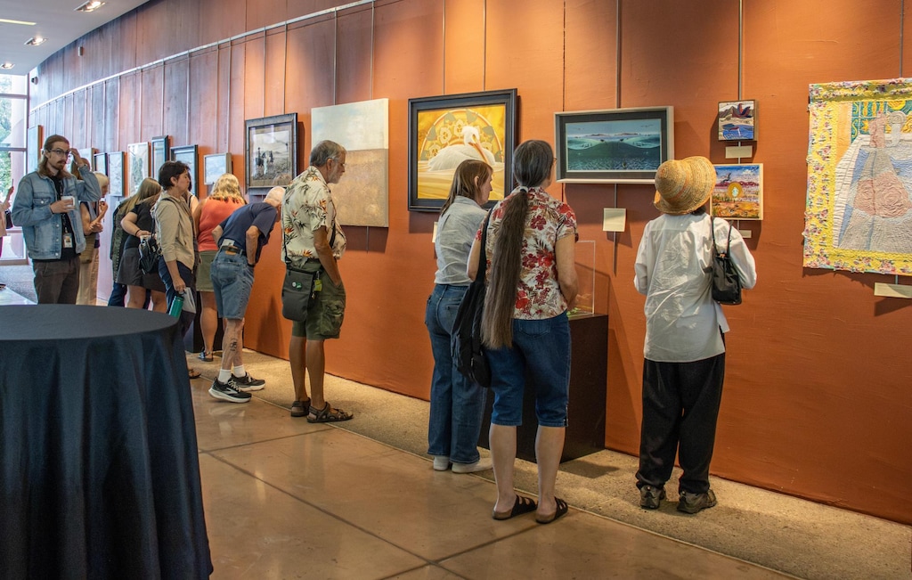 (Zane Poss | Daily Utah Chronicle) Visitors look at the art inspired by the Great Salt Lake and produced through the Alfred Lambourne Arts Program, on display at the Sorensen Unity Center in Salt Lake City on Aug. 28, 2026. The exhibition will run through Nov. 13.