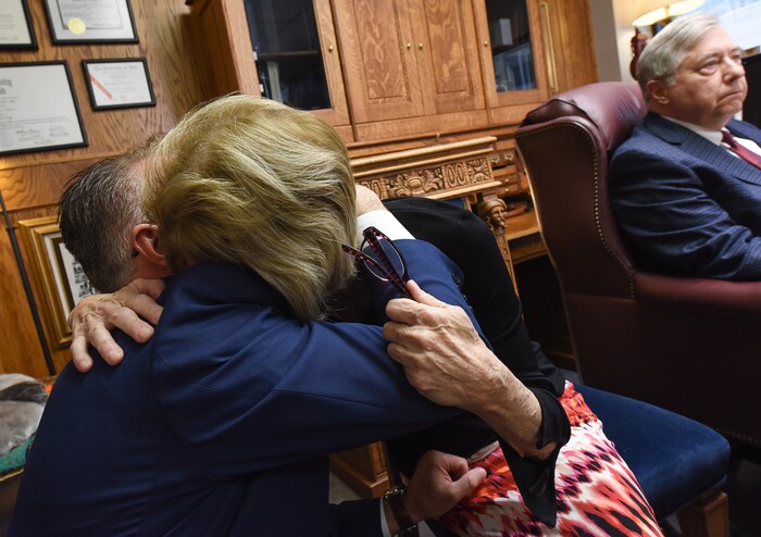 (Francisco Kjolseth  |  The Salt Lake Tribune)  Grant Stanfield embraces his mother Connie Elison, after speaking about their brother and son, Thomas Stanfield, who was shot and killed by a Citadel security guard last week. The two spoke with the press at the office of their attorney Robert Sykes, right, in Salt Lake City on Tuesday, June 26, 2018, after filing a civil rights and wrongful death law suit.