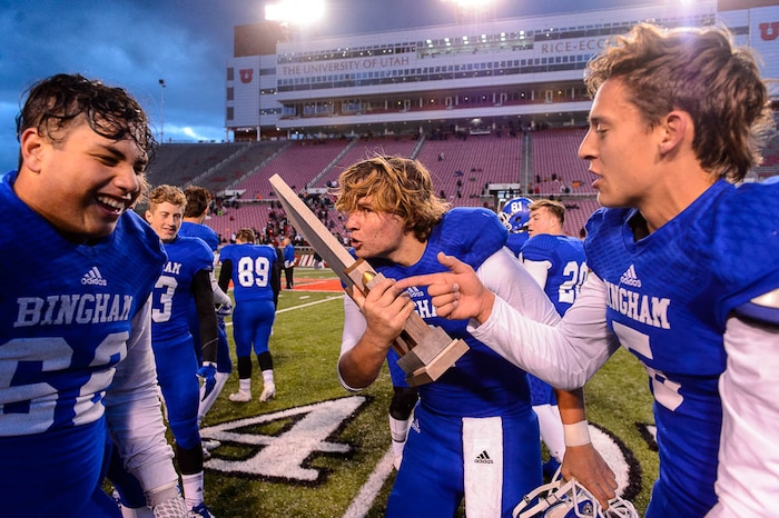 (Trent Nelson | The Salt Lake Tribune)  Bingham's Ryan Wood (2) kisses the championship trophy as Bingham defeats East in the Class 6A High School State Football Championship game in Salt Lake City, Friday November 17, 2017.