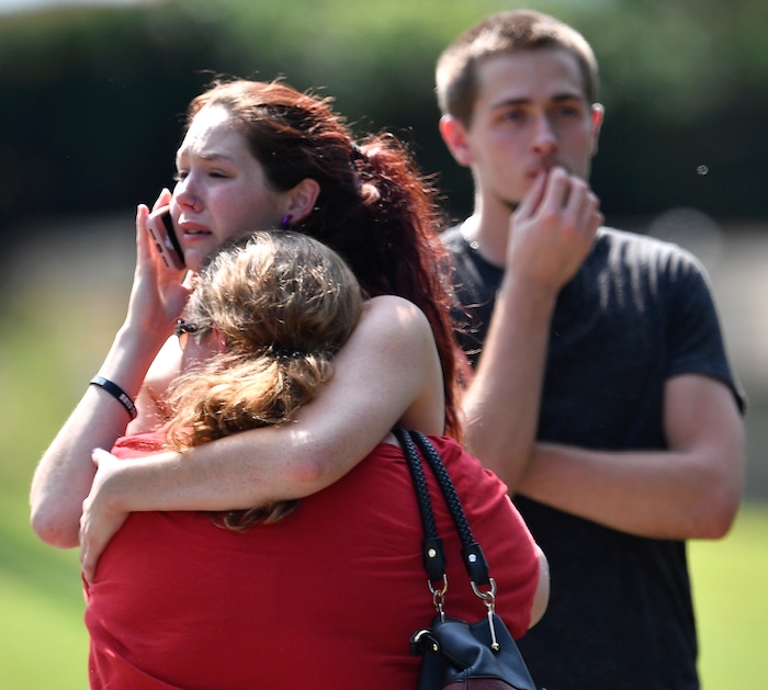 Kaitlyn Adams, a member of the Burnette Chapel Church of Christ, hugs another church member at the scene after shots were fired at the church on Sunday, Sept. 24, 2017, in Antioch, Tenn. (Andrew Nelles/The Tennessean via AP)
