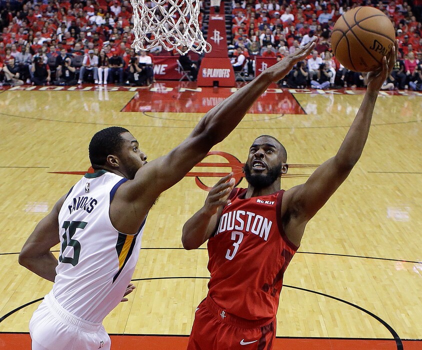 Houston Rockets guard Chris Paul (3) shoots as Utah Jazz forward Derrick Favors defends during the second half of Game 1 of an NBA basketball first-round playoff series, Sunday, April 14, 2019, in Houston. Houston won the game 122-90. (AP Photo/Eric Christian Smith)
