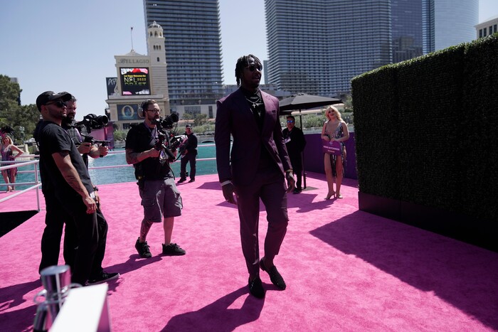 Utah linebacker Devin Lloyd walks to the red carpet during the first round of the NFL football draft Thursday, April 28, 2022, in Las Vegas. (AP Photo/Jae C. Hong )