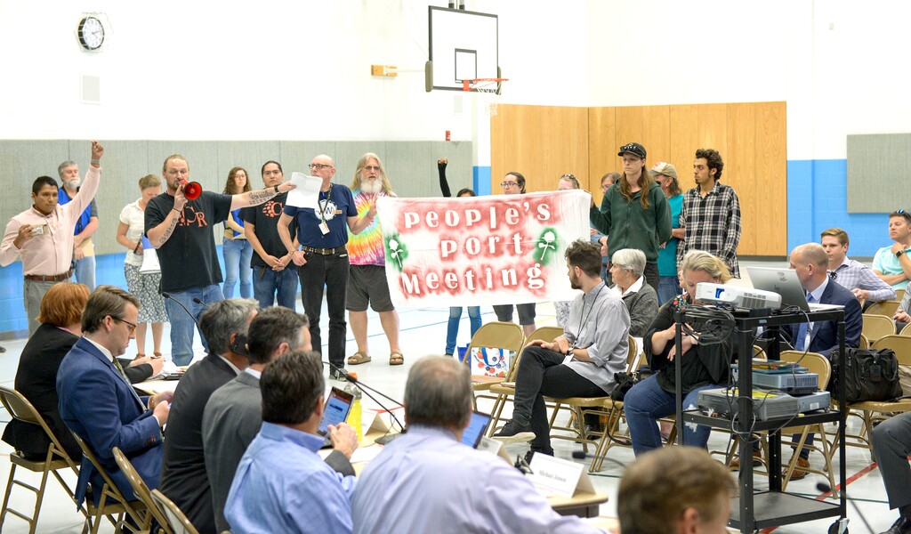 (Leah Hogsten  |  The Salt Lake Tribune)  Ethan Peterson with Civil Riot kicked off the protest shortly after the meeting began. A group called Civil Riot shut down the Inland Port Authority Board meeting at North Star Elementary's gymnasium Wednesday, April 24, 2019 shortly after it began by speaking over board chairman Derek Miller.