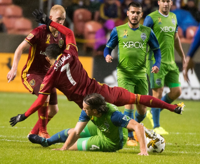 (Rick Egan  |  The Salt Lake Tribune) Seattle Sounders defender Gustav Svensson (4) slides under Real Salt Lake forward Jefferson Savarino (7),in MLS soccer action, Real Salt Lake vs Seattle Sounders, in Sandy, Saturday, September 23, 2017.