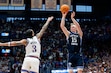 BYU guard Richie Saunders (15) prepares to shoot a 3-point basket as Kansas guard Tre White (3) defends during the second half of an NCAA college basketball game, Saturday, Jan. 31, 2026, in Lawrence, Kan. (AP Photo/Colin E. Braley)