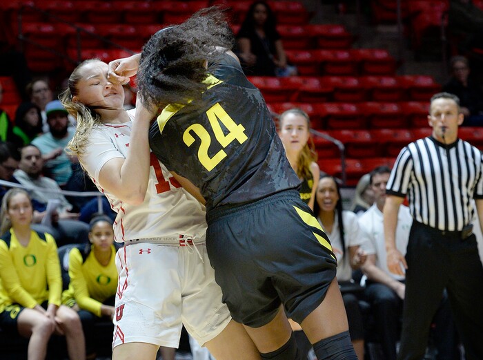 Scott Sommerdorf | The Salt Lake TribuneUtah Utes forward Megan Jacobs (13) took a punch to the eye while grappling with Oregon Ducks forward Ruthy Hebard (24) for a rebound during first half play. Oregon defeated Utah 84-68, Sunday, January 28, 2018.