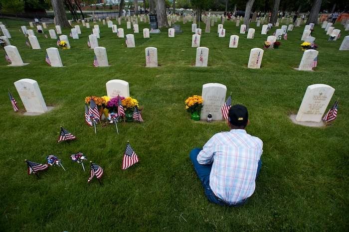 (Rick Egan  |  The Salt Lake Tribune)      
Relatives visit the graves of their loved ones at the Fort Douglas Cemetery after the Memorial Day observance Monday, May 28, 2018.


