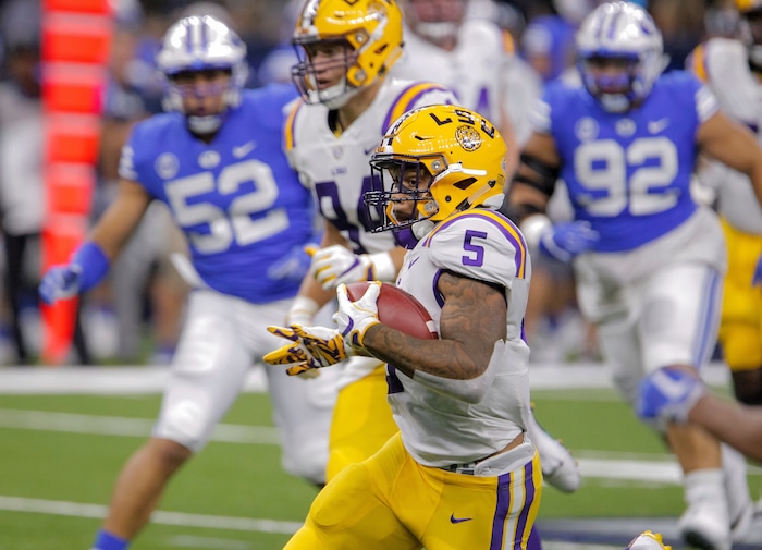 LSU running back Derrius Guice (5) runs against Brigham Young in the first half of an NCAA college football game in New Orleans, Saturday, Sept. 2, 2017. (AP Photo/Scott Threlkeld)