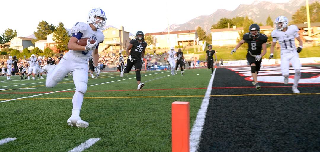 (Leah Hogsten  |  The Salt Lake Tribune) Lehi's Carsen Manookin runs for a touchdown. Lehi High School and Alta High School are tied, 42-42 in the second half during their game, Friday, August 18, 2017 in Sandy. 