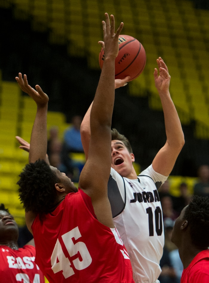 (Rick Egan  |  The Salt Lake Tribune)   East Leopards Mikey Frazier (45) defends as Jordan Beatdiggers Crew Wakley (10), shoots in 5A basketball playoff action between the East Leopards and the Jordan Beatdiggers at the UCCU Center in Orem, Monday, Feb. 26, 2018.