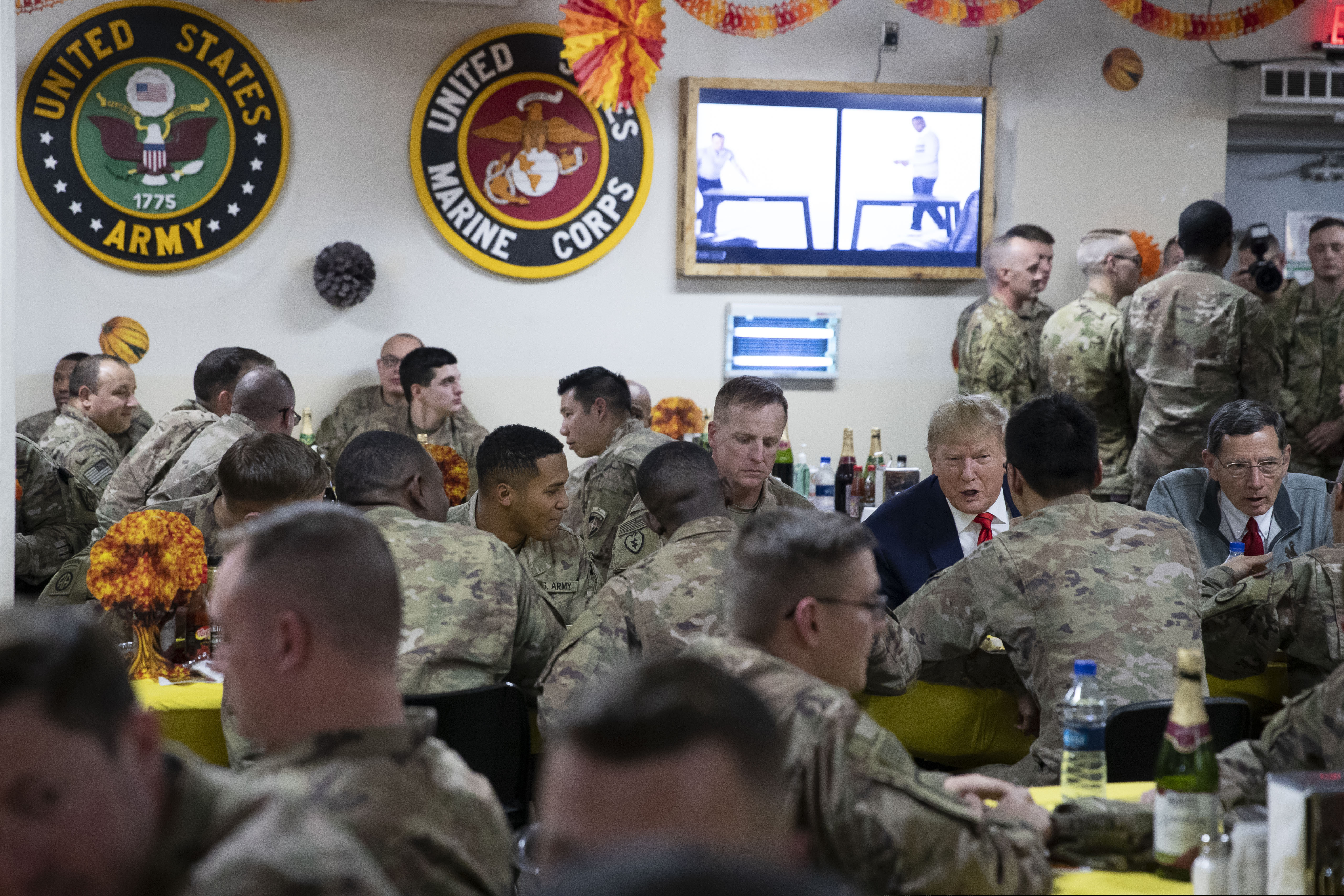 (Alex Brandon | AP) President Donald Trump, accompanied by Sen. John Barrasso, R-Wyo., right, sits down to have dinner with the troops during a surprise Thanksgiving Day visit, Thursday, Nov. 28, 2019, at Bagram Air Field, Afghanistan.