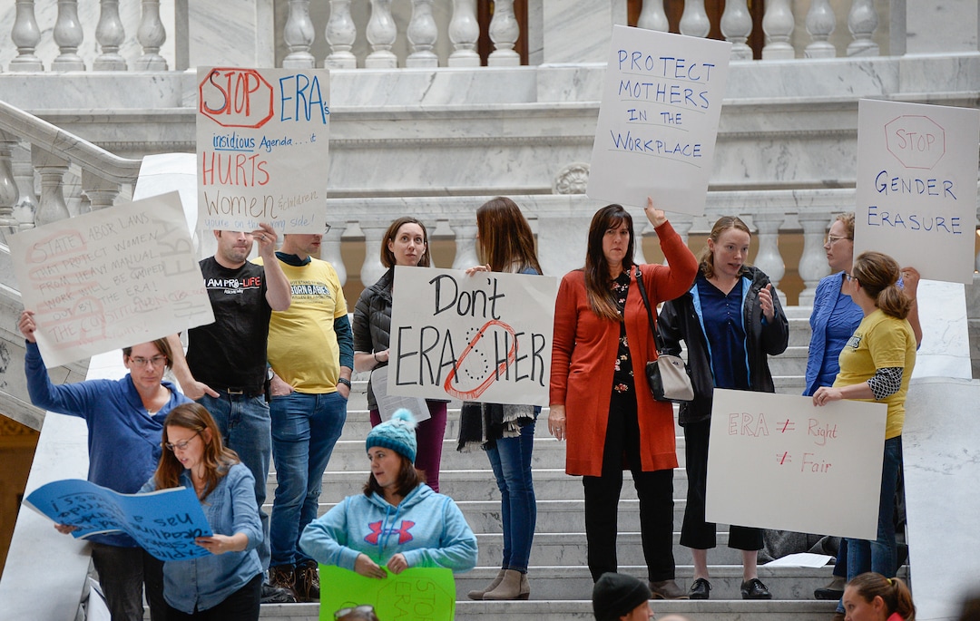 (Francisco Kjolseth  |  The Salt Lake Tribune)  Standing in opposition to those gathered for an Equal Rights Amendment rally at the Utah Capitol, members of Pro Life Utah, the Eagle Forum, Big Ocean Women, Gathering Families and Abortion Free Utah hold signs on the other side of the Capitol rotunda on Tuesday, Dec. 3, 2019.