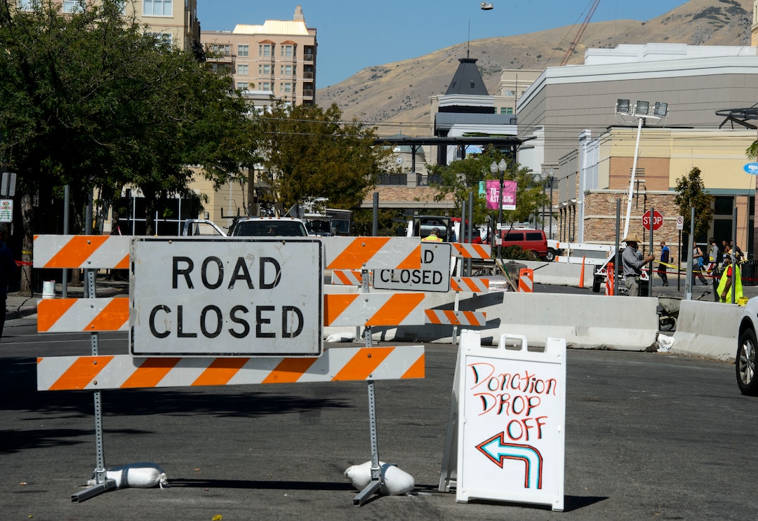 (Steve Griffin  |  The Salt Lake Tribune) Workers cement  fence posts into position on Rio Grande Street in Salt Lake City Monday September 11, 2017.