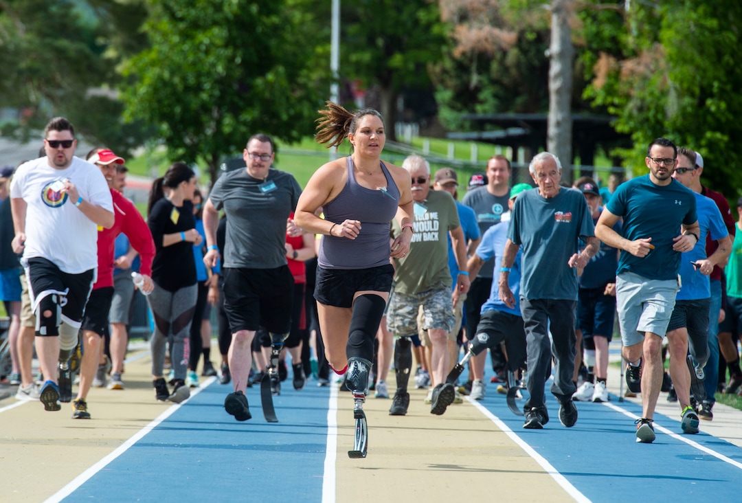 (Rick Egan  |  The Salt Lake Tribune)     Pam Hennessy, from South Jordan, leads a group of runners around the track, during the fourth annual Utah Adaptive Mobility Clinic at Skyline High school. The clinic allows anyone with "lower extremity limb loss or limb difference" or amputees without legs, to practice walking and running. Saturday, June 1, 2019.