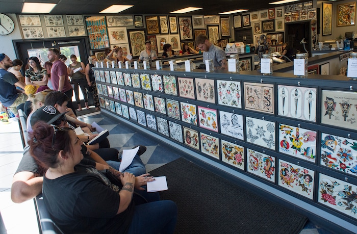 (Rick Egan | The Salt Lake Tribune) Clients wait their turn at the Yellow Rose Tattoo for a flash tattoo event where all proceeds go to the Rape Recovery Center of Utah. It's part of a national event where tattoo shops raise money for sexual assault victims. Sunday, June 10, 2018.