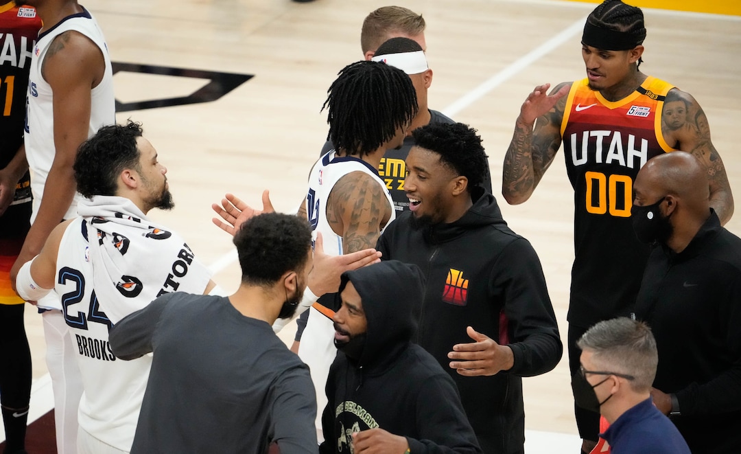 (Francisco Kjolseth | The Salt Lake Tribune) Utah Jazz guard Donovan Mitchell (45) celebrates their teams 126-110 win over Memphis as Memphis Grizzlies forward Dillon Brooks (24) congratulates him following the second half of Game 5 of an NBA basketball first-round playoff series Wednesday, June 2, 2021, in Salt Lake City, UT.