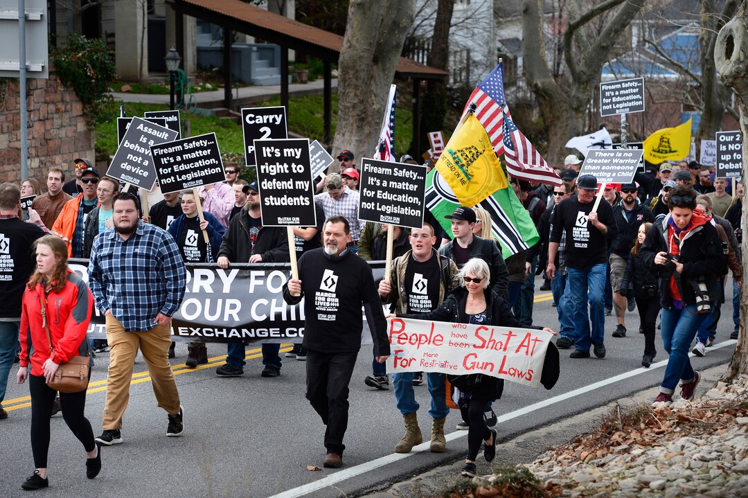 (Scott Sommerdorf | The Salt Lake Tribune) The pro gun "March Before Our lives" marchers march up State Street to the Utah State Capitol building, Saturday, March 24, 2018.