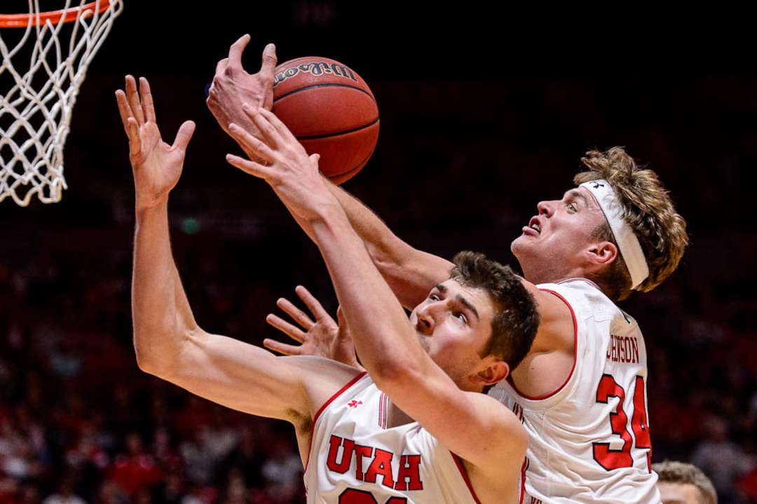(Trent Nelson | The Salt Lake Tribune)  Utah Utes forward Riley Battin (21) and Utah Utes center Jayce Johnson (34) reach for a rebound as Utah hosts Oregon State, NCAA basketball in Salt Lake City on Saturday Feb. 2, 2019.