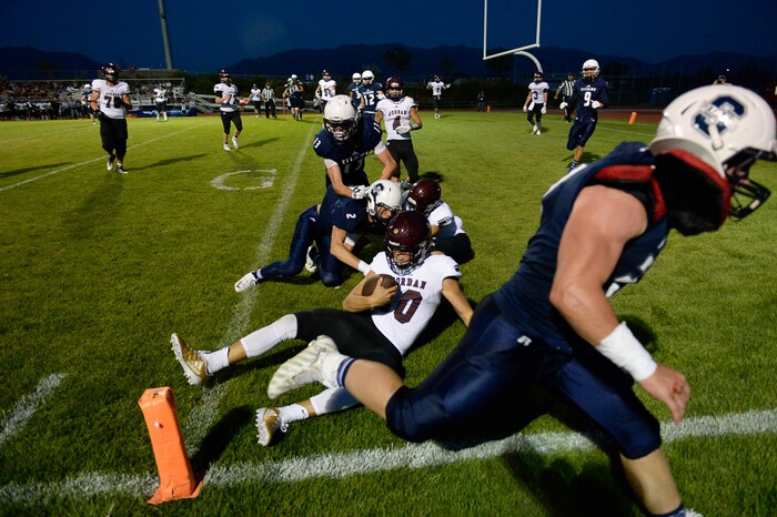 (Francisco Kjolseth  |  The Salt Lake Tribune)  Jordan quarterback Crew Wakley runs the ball into the end zone for a touchdown in the third quarter against Syracuse in game action at Syracuse on Thursday, Aug. 24, 2017.