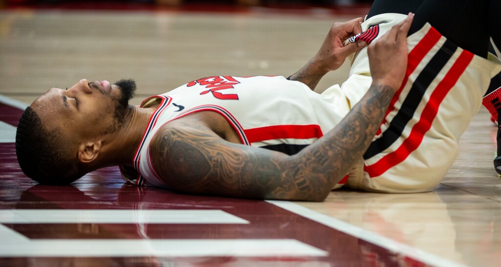 (Rick Egan  |  The Salt Lake Tribune)     Portland Trail Blazers guard Damian Lillard (0) lies on the floor after being knocked down, in the Jazz 117-114 win over the Portland Trail Blazers, in NBA action in Salt Lake City, Friday, Feb. 7, 2020.