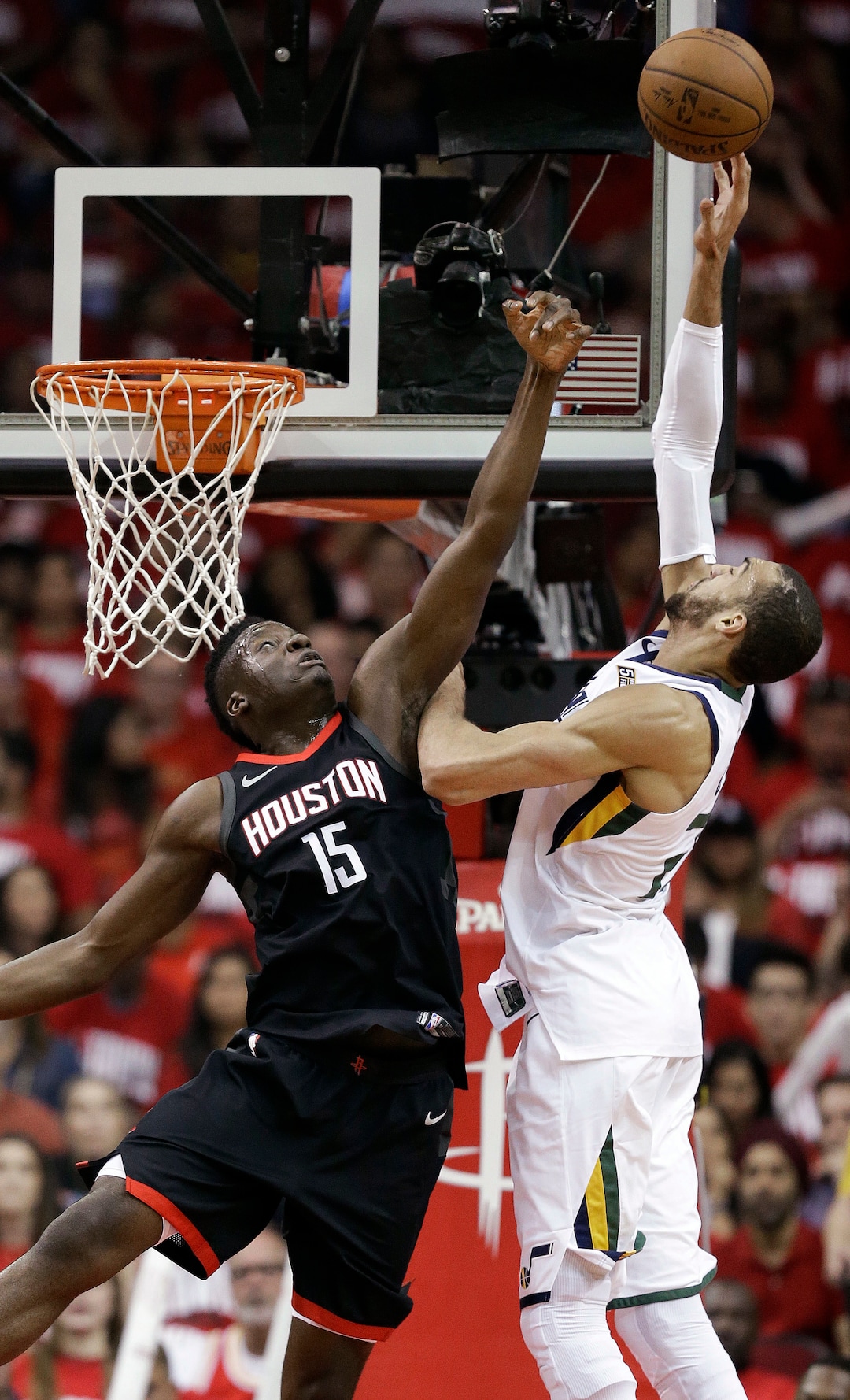Houston Rockets center Clint Capela (15) and Utah Jazz center Rudy Gobert reach for a pass during the first half in Game 2 of an NBA basketball second-round playoff series, Wednesday, May 2, 2018, in Houston. (AP Photo/Eric Christian Smith)