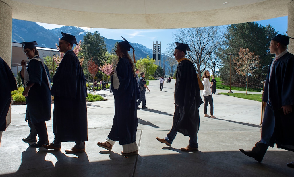 (Rick Egan  |  The Salt Lake Tribune)        Brigham Young University Graduates make their way to the Marriott Center for the 144th BYU Commencement, Thursday, April 25, 2019. 
