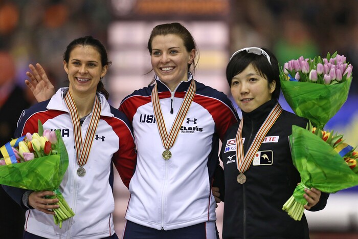New world champion Heather Richardson of the U.S., center and gold medal, Brittany Bowe of the U.S., left and silver medal, and Nao Kodaira of Japan, right and bronze medal, pose on the podium of the women's 500 meter race of the speedskating single distance world championships at Thialf ice rink in Heerenveen, Netherlands, Saturday, Feb. 14, 2015. (AP Photo/Peter Dejong)