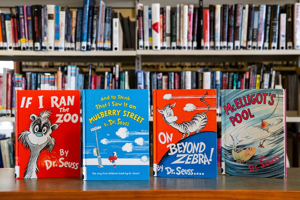 (Christopher Dolan | The Times-Tribune via AP) Dr. Seuss childrens' books, from left, "If I Ran the Zoo," "And to Think That I Saw It on Mulberry Street," "On Beyond Zebra!" and "McElligot's Pool" are displayed at the North Pocono Public Library in Moscow, Pa., Tuesday, March 2, 2021. Dr. Seuss Enterprises, the business that preserves and protects the author's legacy said Tuesday, that these four titles, as well as “Scrambled Eggs Super!,” and “The Cat’s Quizzer,” will no longer be published because of racist and insensitive imagery.