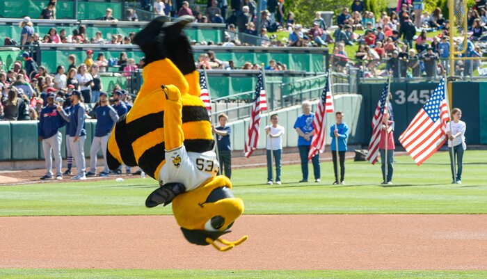 (Francisco Kjolseth  |  The Salt Lake Tribune)  Putting on a show, Bumble does a back flip on the field before the start of the Bee's game against the Rainiers at Smith's Ballpark  during the annual staging of the kids day game on Thursday, May 2, 2019.
