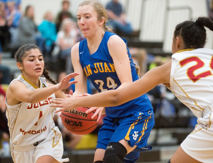 (Rick Egan  |  The Salt Lake Tribune)   San Juan forward Madi Palmer (24) tries to get between the Judge Memorial defenders,Emily Garcia (1) and  Miyalla Tarver (24), in 3A Women's basketball State playoff action Judge Memorial vs. San Juan, in Heber City, Friday, Feb. 16, 2018.
