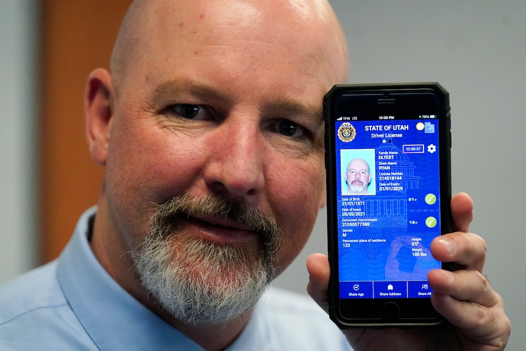(Rick Bowmer | The Associated Press) Ryan Williams, with the Utah Driver License Division, displays his cellphone with the pilot version of the state's mobile ID on Wednesday, May 5, 2021, in West Valley City. The card that millions of people use to prove their identity to everyone from police officers to liquor store owners may soon be a thing of the past as a growing number of states develop digital driver's licenses.