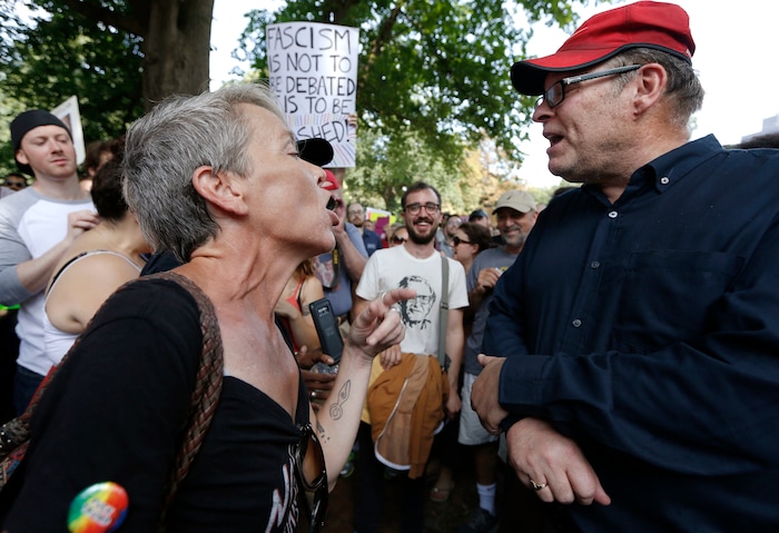Protesters with opposing views face off at a "Free Speech" rally organized by conservative activists on Boston Common, Saturday, Aug. 19, 2017, in Boston.  Thousands of demonstrators marched Saturday from the city’s Roxbury neighborhood to Boston Common, where the “Free Speech Rally” is being held. (AP Photo/Michael Dwyer)