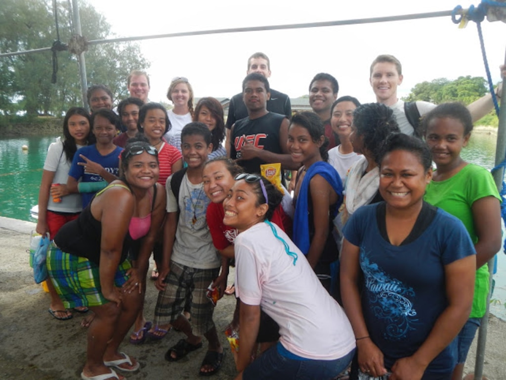 (Eli McCann) Eli McCann attends a youth conference in Palau with a group of smiling Latter-day Saints.