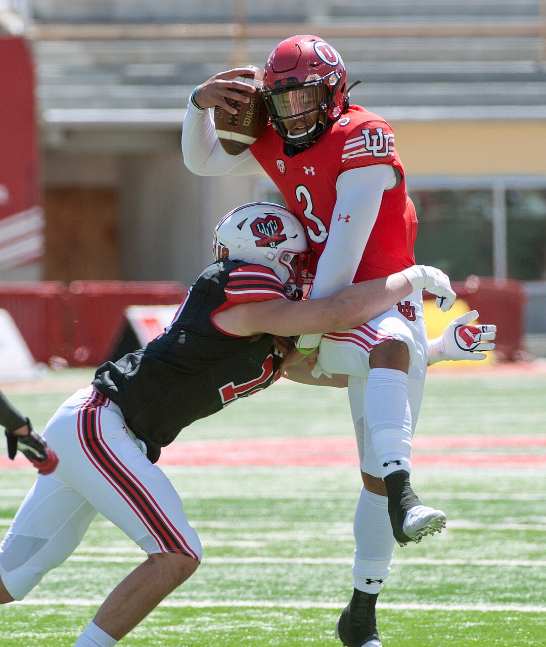 (Ed Kosmicki | Special to The Tribune) The red team's Drew Rawls is wrapped up by a black team defenseman during the annual spring football game at the University of Utah, 17 April 2021.