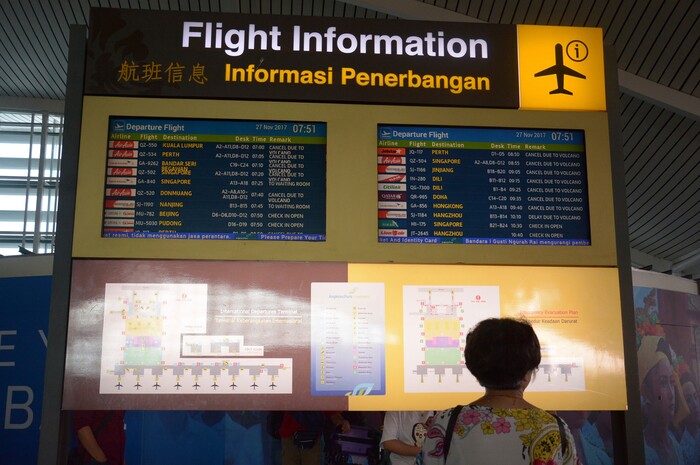 (Ketut Nataan | The Associated Press) A flight information board shows cancelled flights at Ngurah Rai International Airport in Bali, Indonesia, Monday, Nov. 27, 2017. Indonesian authorities raised the alert for a rumbling volcano on Bali to the highest level on Monday, stranding tens of thousands of travelers as ash clouds forced the closure of the tourist island's international airport.