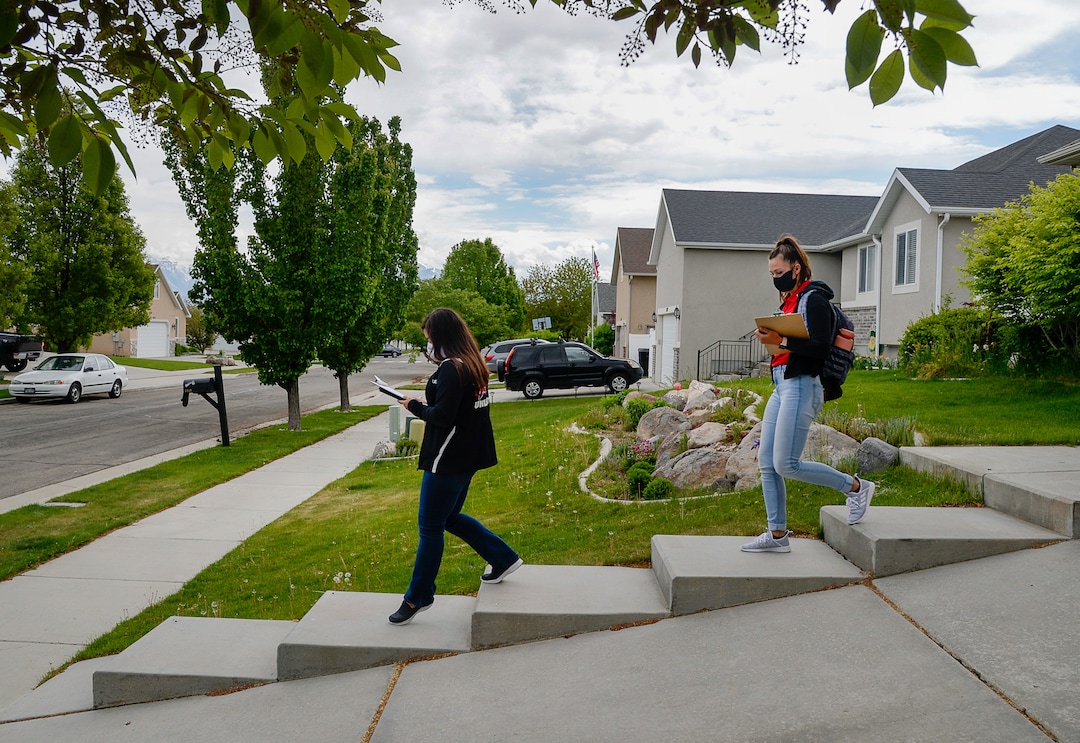 (Francisco Kjolseth  |  The Salt Lake Tribune) University of Utah students Raquel Bucio, left, and Baylee Tollerud visit randomly selected households in Herriman on Thursday, May 4, 2020, to explain the Utah Health & Economic Recovery Outreach program in hopes of finding people willing to be tested for COVID-19, to find out how widespread the disease actually is in the state. Educators and business leaders are hoping the HERO program, where college-age volunteers are now randomly finding residents to be tested for COVID-19, will blossom into something bigger. They are proposing to expand it into what will be called Hope Corps, with hundreds of students and other volunteers offering hands-on advice and resources to restaurants and retailers who's businesses are struggling in the pandemic.