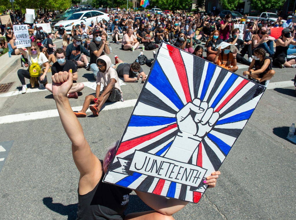 (Rick Egan  |  The Salt Lake Tribune)  Marchers pause in the street as they read the names of black people that have been killed by police, during a a Juneteenth march in the streets of Salt Lake City, Friday, June 19, 2020.