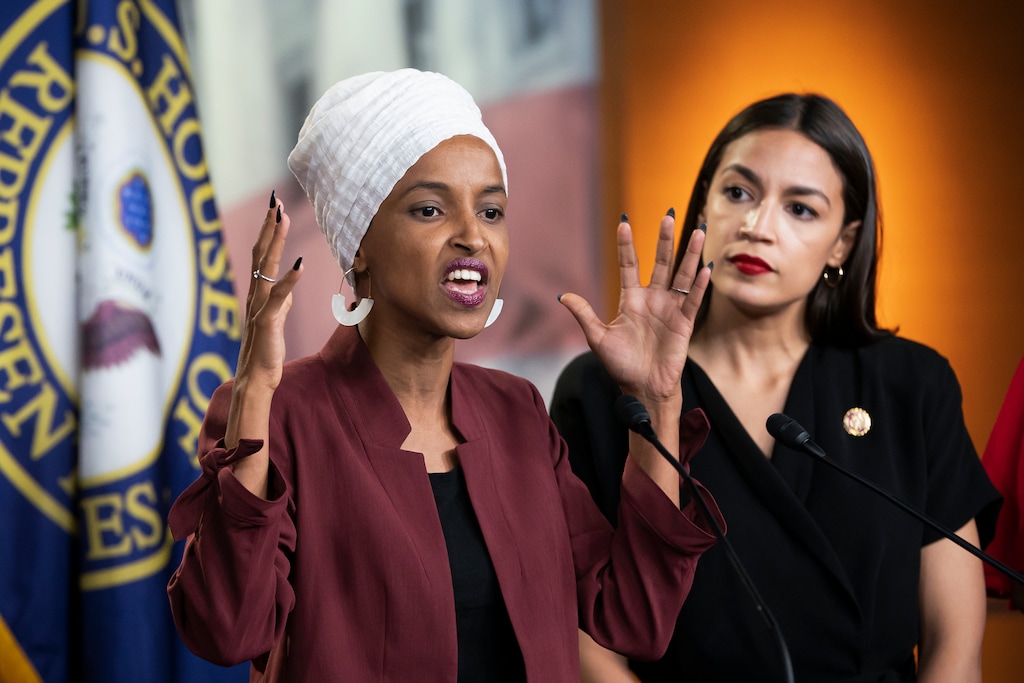 U.S. Rep. Ilhan Omar, D-Minn., left, joined at right by U.S. Rep. Alexandria Ocasio-Cortez, D-N.Y., responds to base remarks by President Donald Trump after he called for four Democratic congresswomen of color to go back to their "broken" countries, as he exploited the nation's glaring racial divisions once again for political gain, during a news conference at the Capitol in Washington, Monday, July 15, 2019. All four congresswomen are American citizens and three of the four were born in the U.S. Omar is the first Somali-American in Congress. (AP Photo/J. Scott Applewhite)