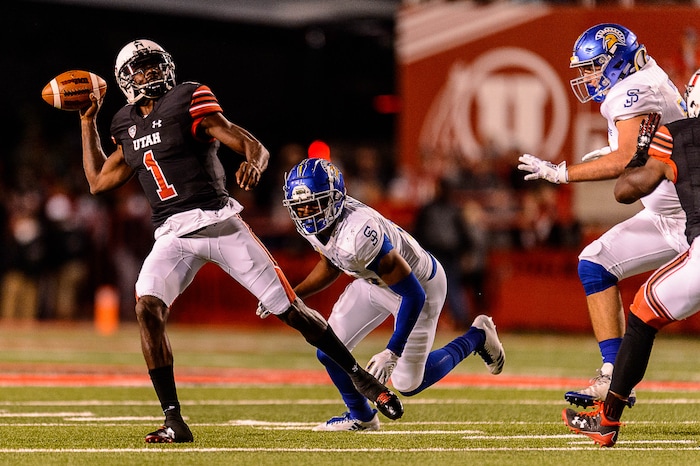 (Trent Nelson | The Salt Lake Tribune) Utah Utes quarterback Tyler Huntley (1) avoids San Jose State Spartans safety Maurice McKnight (10) as the Utah Utes host the San Jose State Spartans, NCAA football at Rice-Eccles Stadium in Salt Lake City, Saturday September 16, 2017.