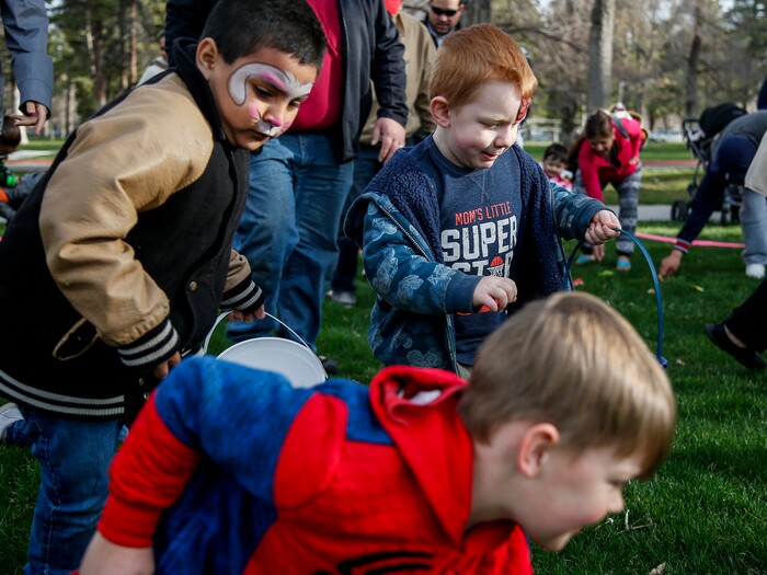 (Nicole Boliaux | For The Tribune) Children and their families run to grab Easter eggs during the annual Easter egg hunt put on by A Kid's Place Dentistry in Liberty Park in Salt Lake City on Saturday, March 31, 2018.
