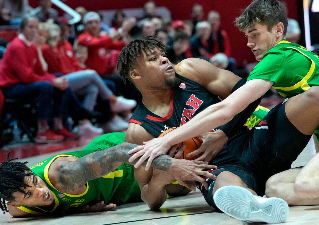 (Leah Hogsten | The Salt Lake Tribune) Utah Utes guard Wilguens Exacte Jr. (11) looks for the pass while hitting the deck with Oregon Ducks guard Rivaldo Soares (11) and Oregon Ducks guard Brennan Rigsby (4) as the University of Utah hosts Oregon at the Huntsman Center, Jan. 7, 2023.