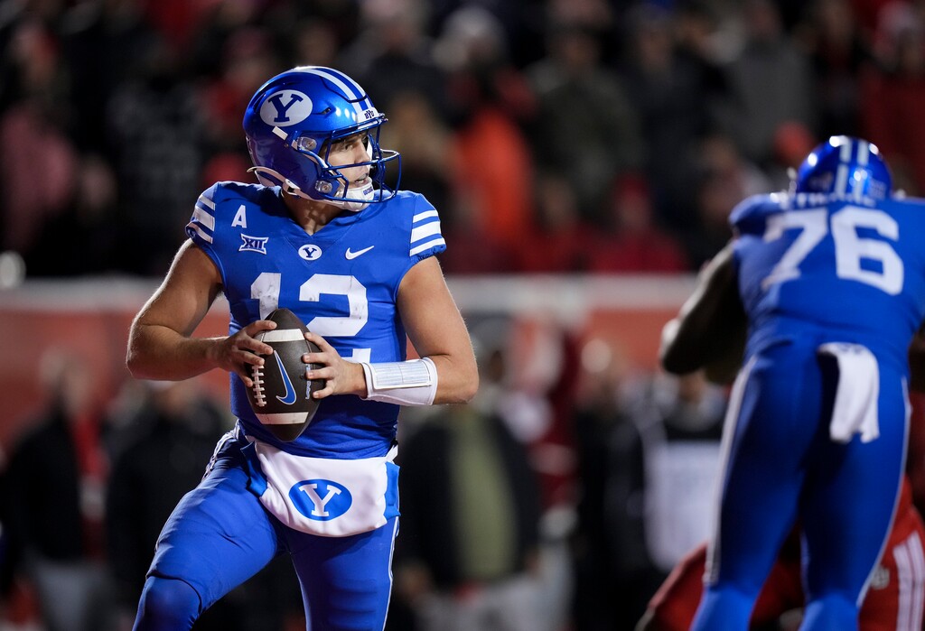 (Bethany Baker | The Salt Lake Tribune) Brigham Young Cougars quarterback Jake Retzlaff (12) looks to pass during a game against the Utah Utes on Nov. 10, 2024. On Wednesday, a Salt Lake County woman filed a civil lawsuit alleging Retzlaff sexual assaulted her in 2023.