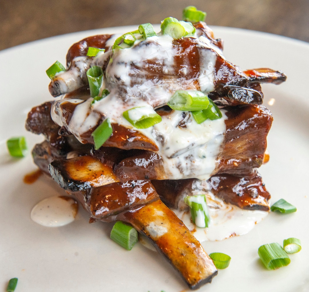 (Rick Egan  |  The Salt Lake Tribune)      Lamb Riblets, herb roasted, char grilled riblets in house-made espresso stout BBQ sauce, topped with buttermilk blue cheese and green onions, at MacCool's Public House in Layton, Thursday, Feb. 6, 2020.


.