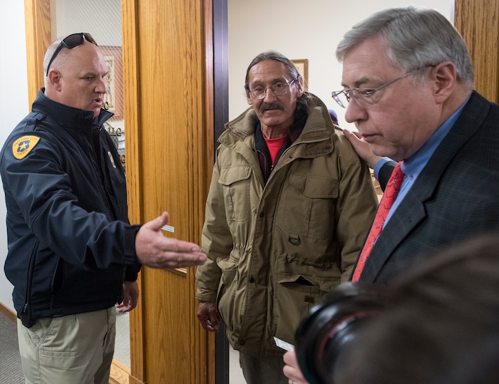 (Rick Egan  |  The Salt Lake Tribune)  Attorney, Robert Sykes (right)  turns over his client, Jackie Sanchez, to the Salt Lake City police, after they came up to his 2nd floor office to get him at his attorneys office, after media conference about an abuse of force claim to be filed against the Salt Lake City Police, when Sanchez was attacked by a police dog on July 28. Wednesday, December 6, 2017.


