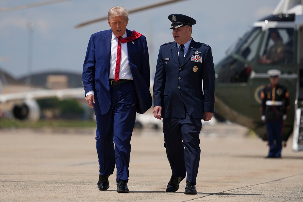 President Donald Trump speaks with Col. Paul R. Pawluk, Deputy Commander of the 89th Airlift Wing, at Joint Base Andrews in Maryland, on June 20, 2025. Trump on Saturday sent U.S. warplanes to bomb three nuclear sites in Iran. (Eric Lee/The New York Times)